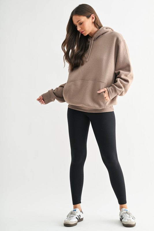 Cozy neutral women’s hoodie styled with leggings