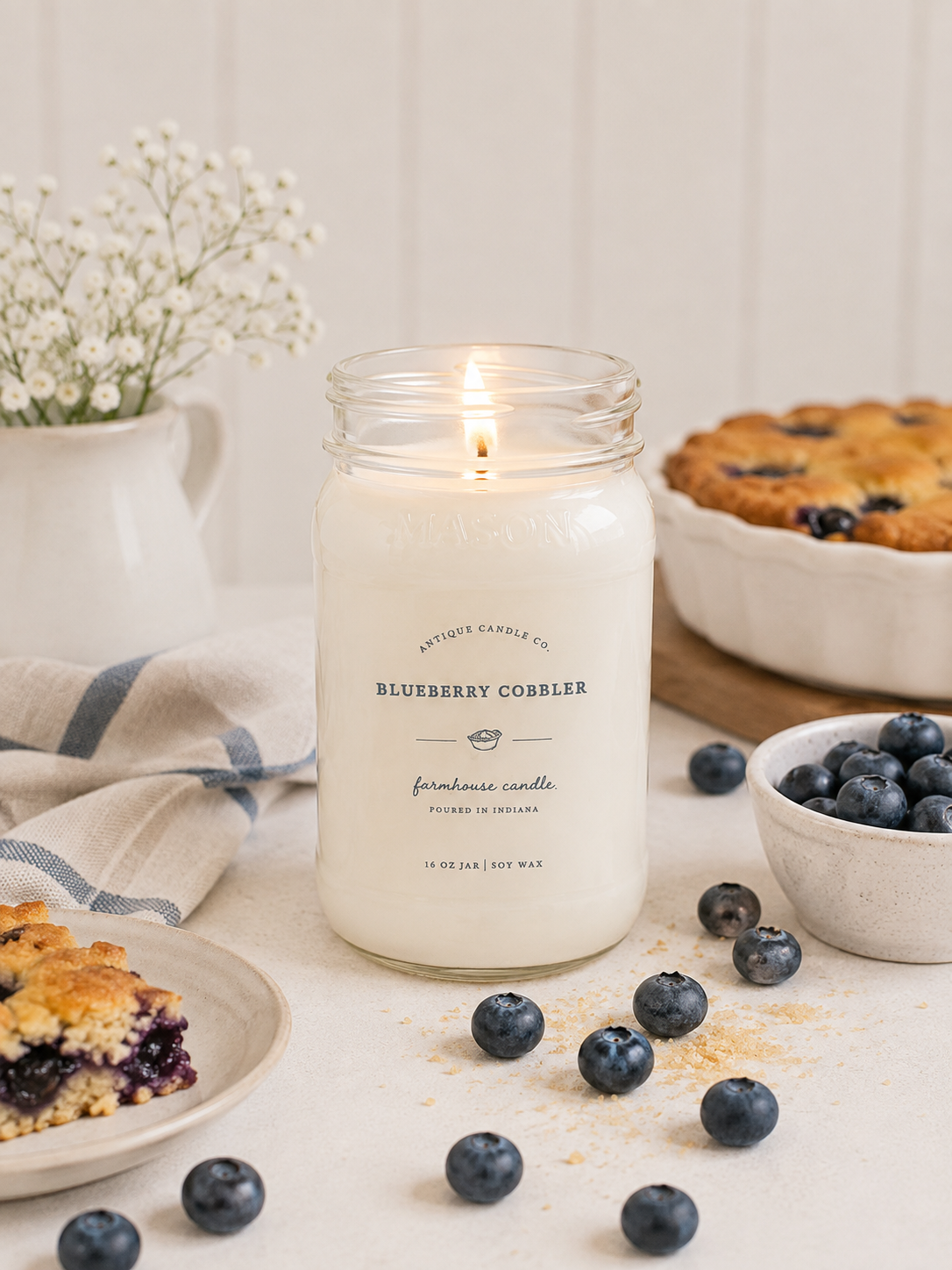 Antique Candle Co. Blueberry Cobbler soy candle in a reusable glass jar with sweet blueberry, buttery pastry, cinnamon, and vanilla fragrance.