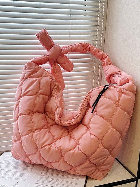 pastel coral quilted puffer shoulder bag with adjustable tie strap and zipper closure