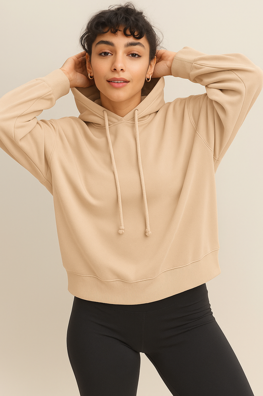 Women wearing a soft cozy hoodie in a warm sandstone color.