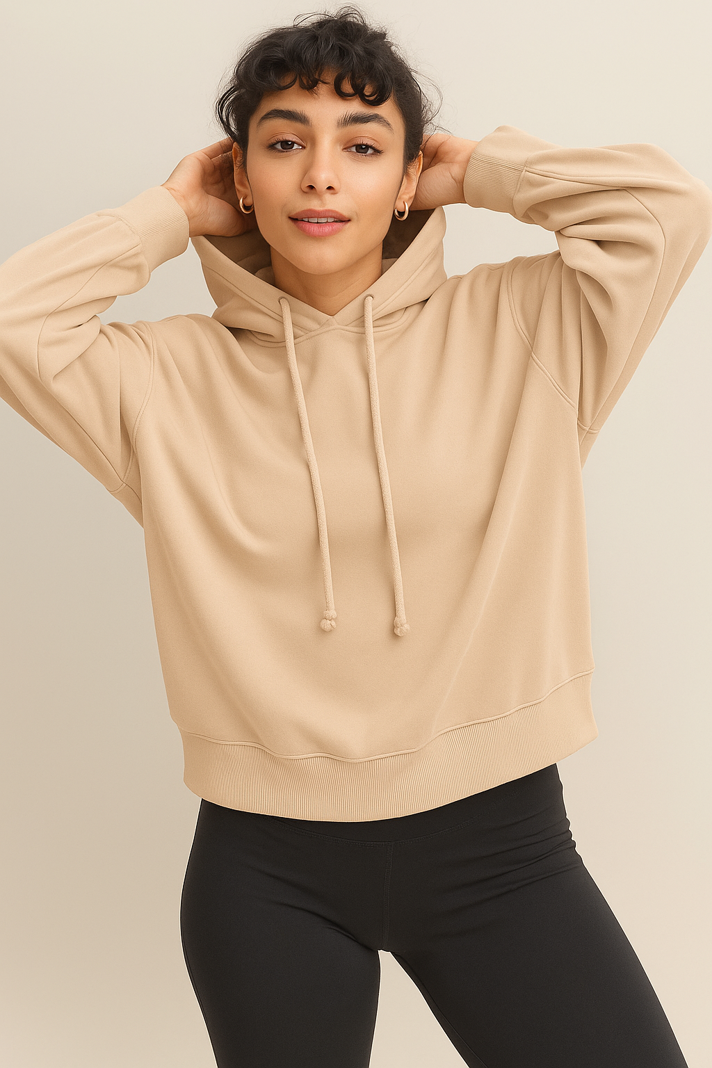 Women wearing a soft cozy hoodie in a warm sandstone color.