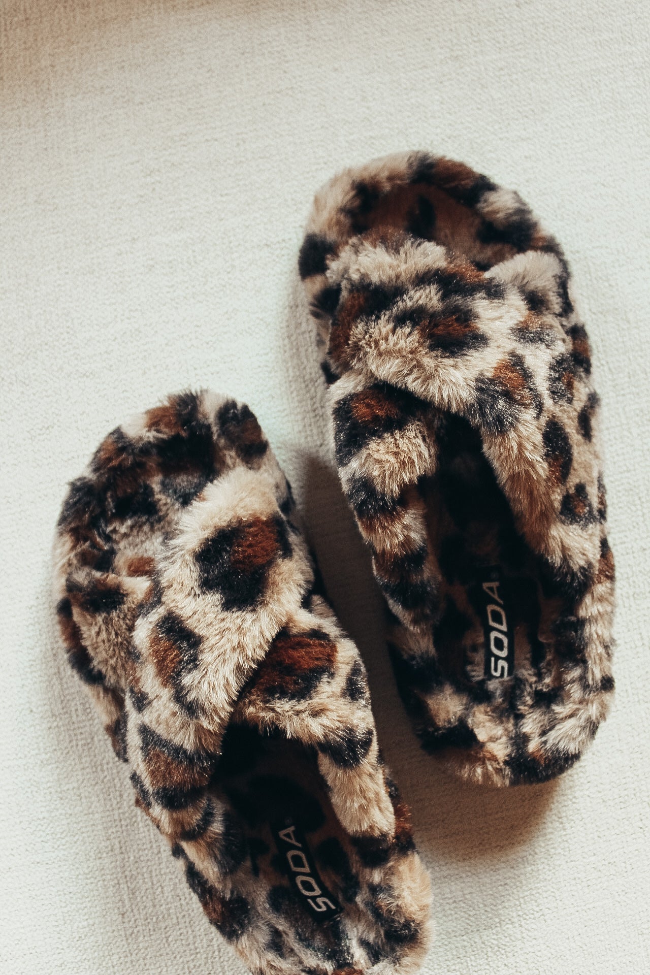 Leopard fur slippers.