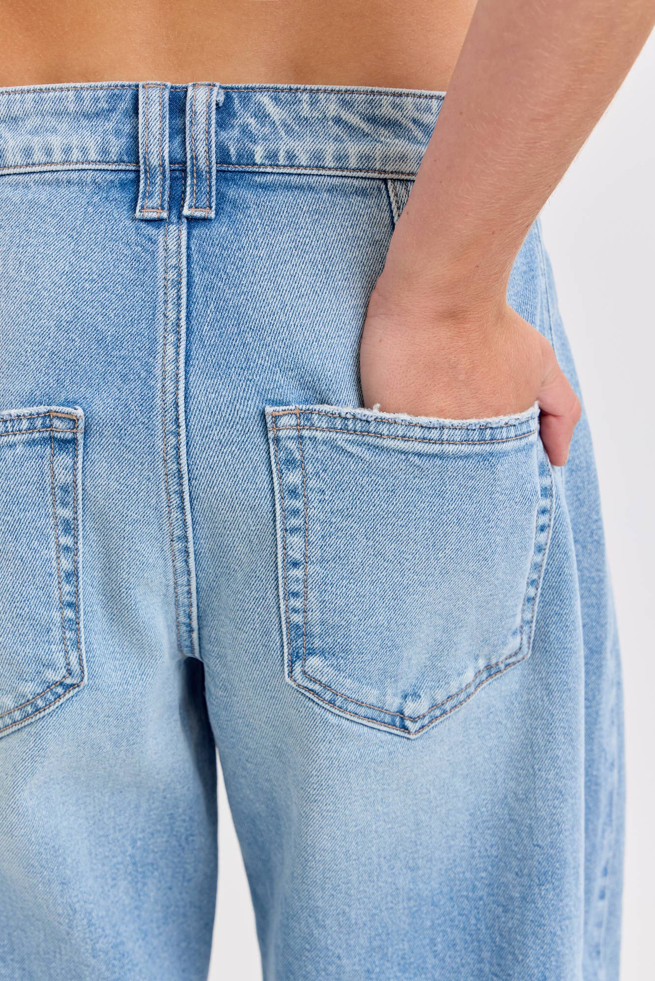 Light blue jeans with a pocket on a white background
