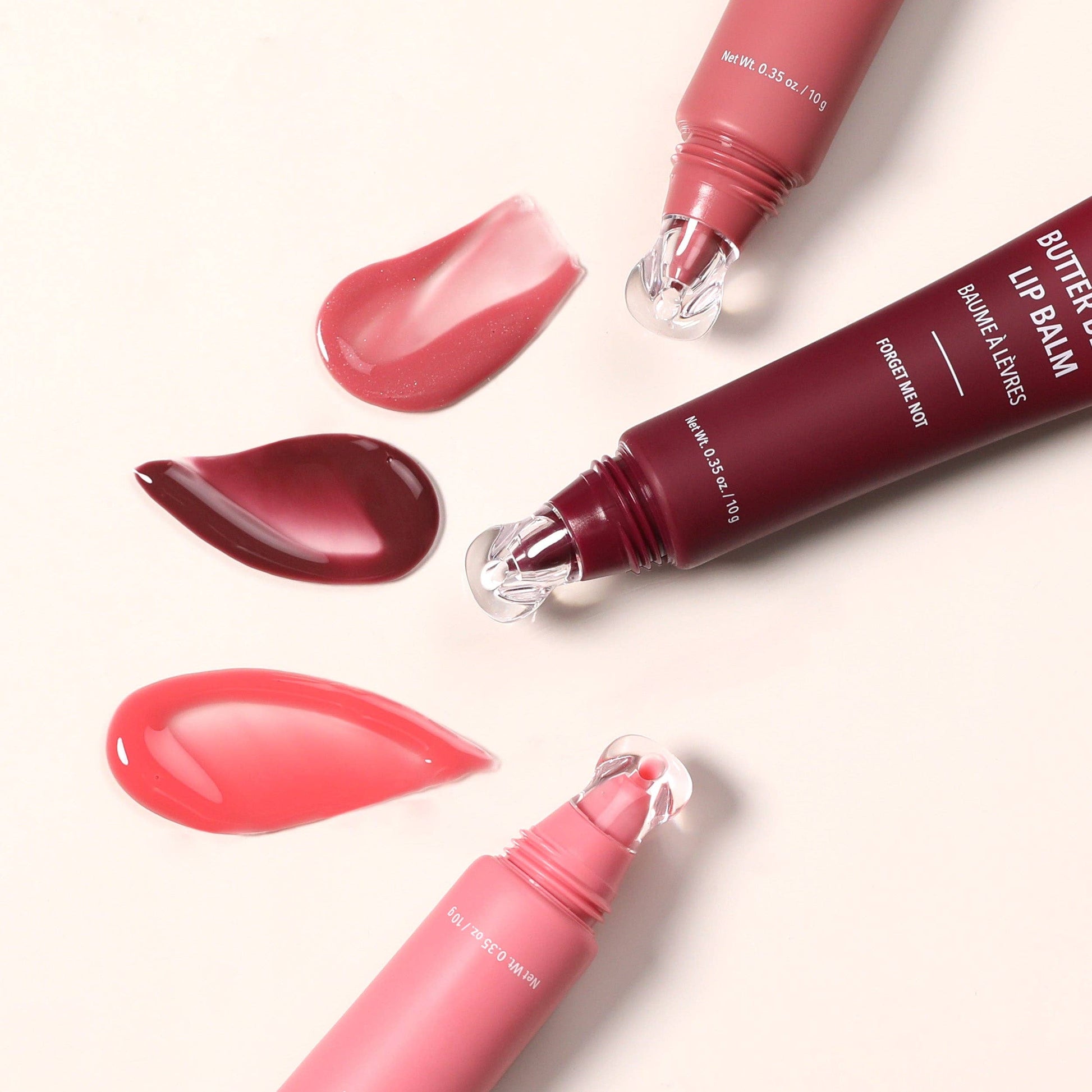 Butter London lip balm with pink and red shades on a white background