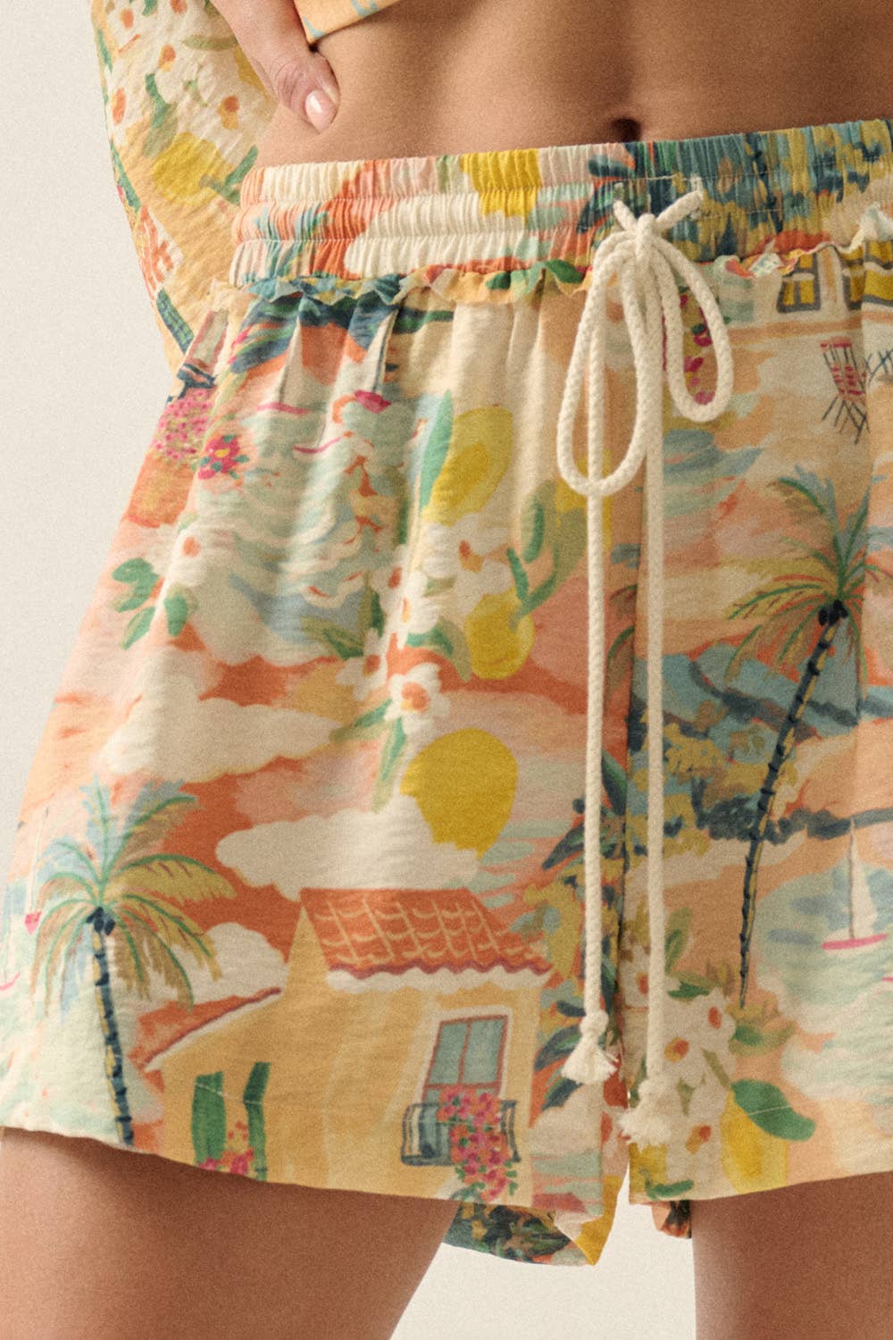 Colorful beach-themed shorts with a drawstring on a neutral background