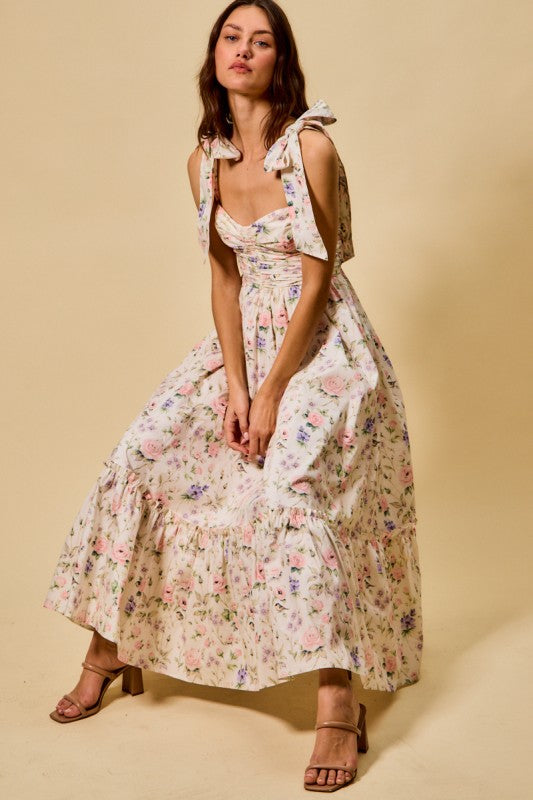 Woman wearing a floral dress against a beige background
