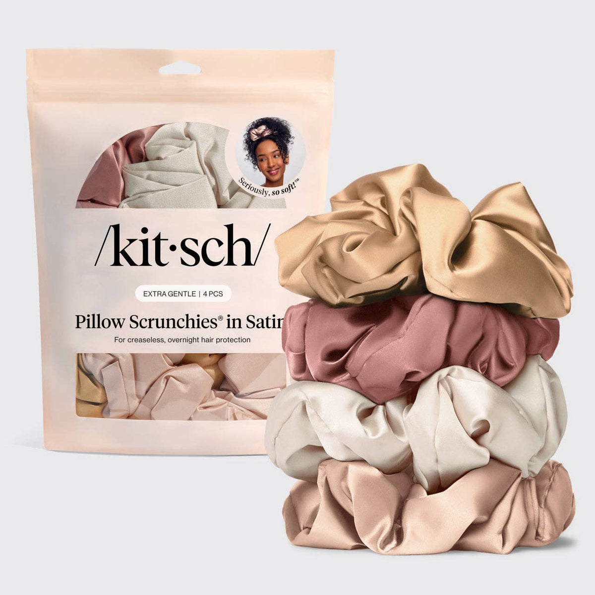 A package of KITSCH Pillow Scrunchies in Satin next to a stack of four satin scrunchies in champagne, dusty rose, cream, and blush pink.