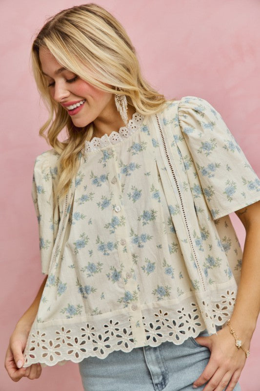 Cream floral blouse with blue flowers and eyelet lace trim front view