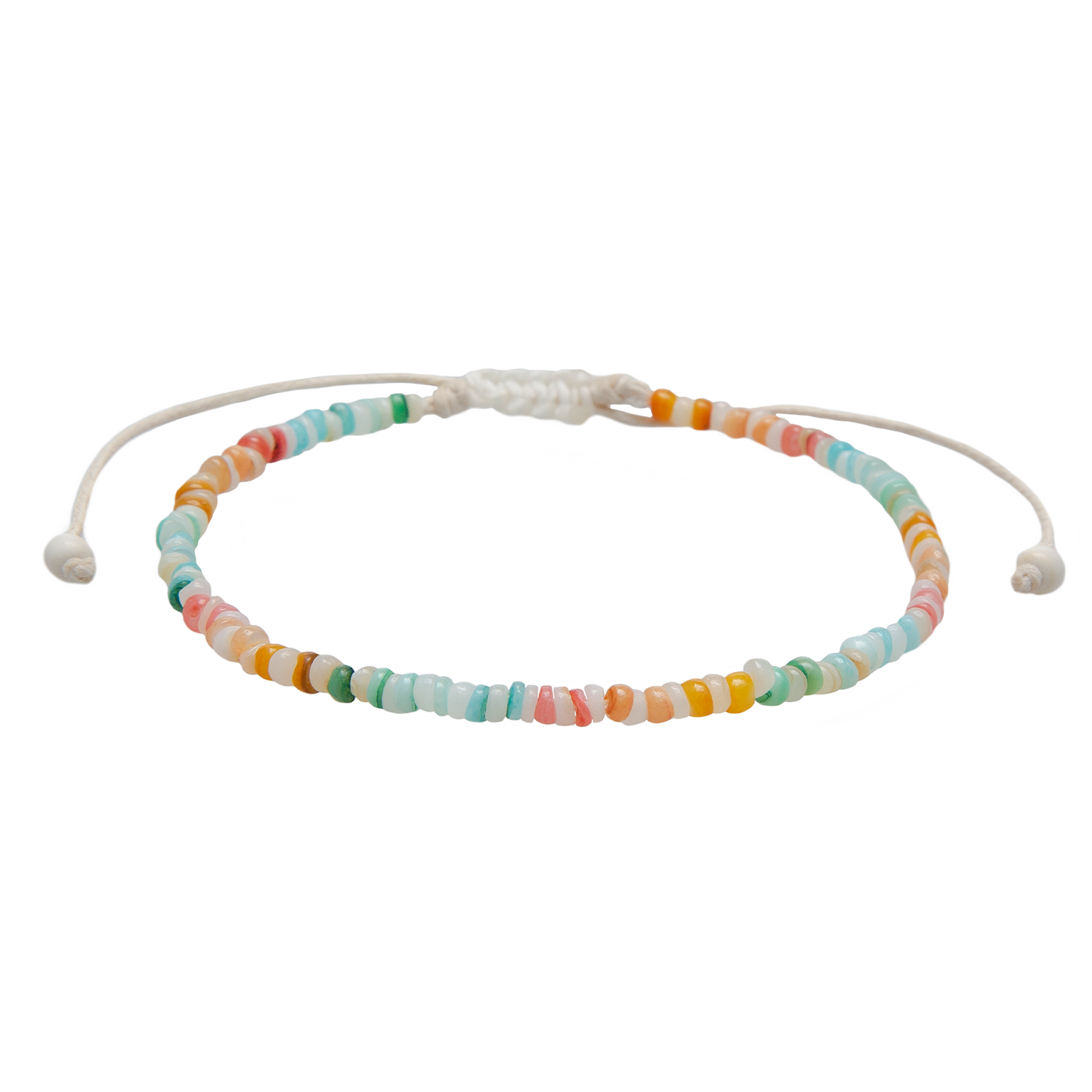 Handcrafted puka shell anklet featuring genuine shell beads, colorful accent beads, and an adjustable cotton cord inspired by coastal summer style.