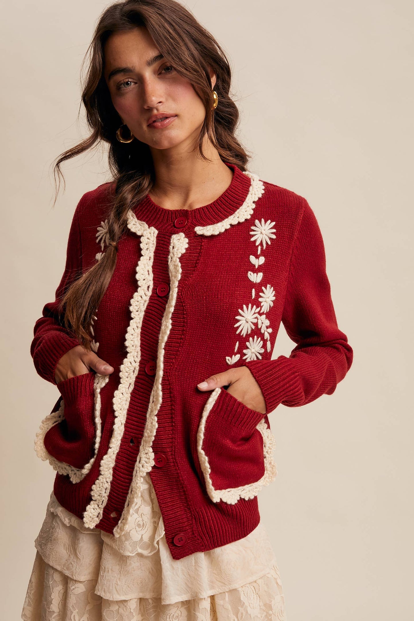 Vintage-inspired cranberry cardigan with cream crochet trim and daisy embroidery. Cozy, feminine, and perfect for holiday dressing.