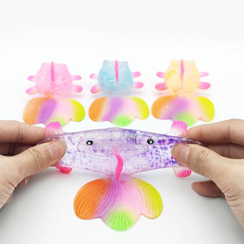 Colorful jellyfish toys with hands holding one toy against a white background