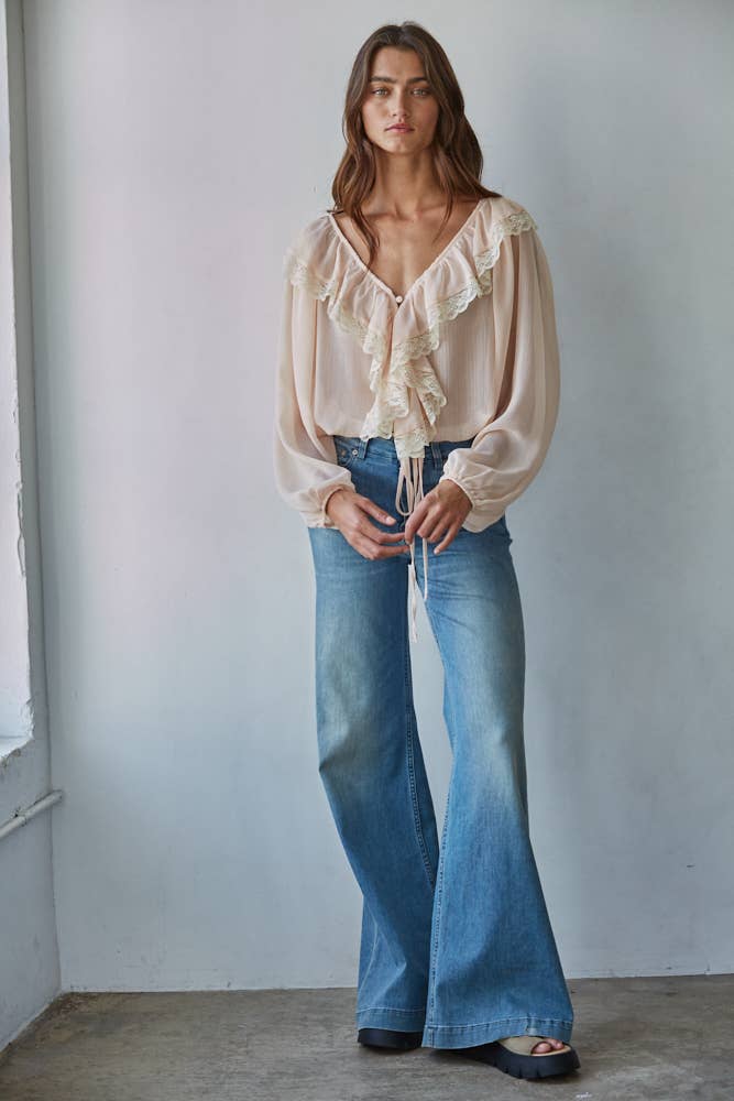 Romantic ruffle front blouse styled with denim
Back view of sheer lace ruffle blouse
