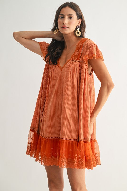Boho orange babydoll dress with lace details. 