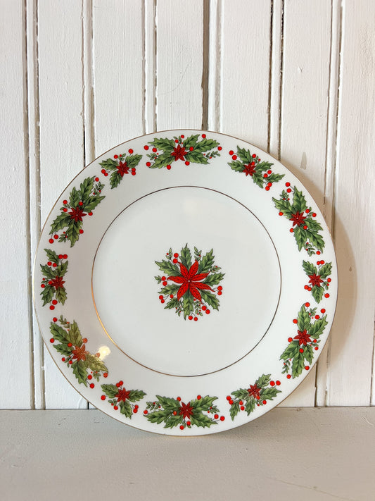 vintage white porcelain Christmas plate with red poinsettias and green holly leaf pattern around the edge