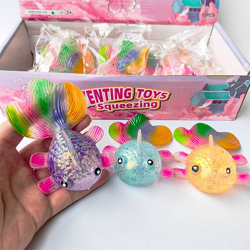 Colorful squishy toys with a box labeled 'Squeezing Toys' on a white surface.