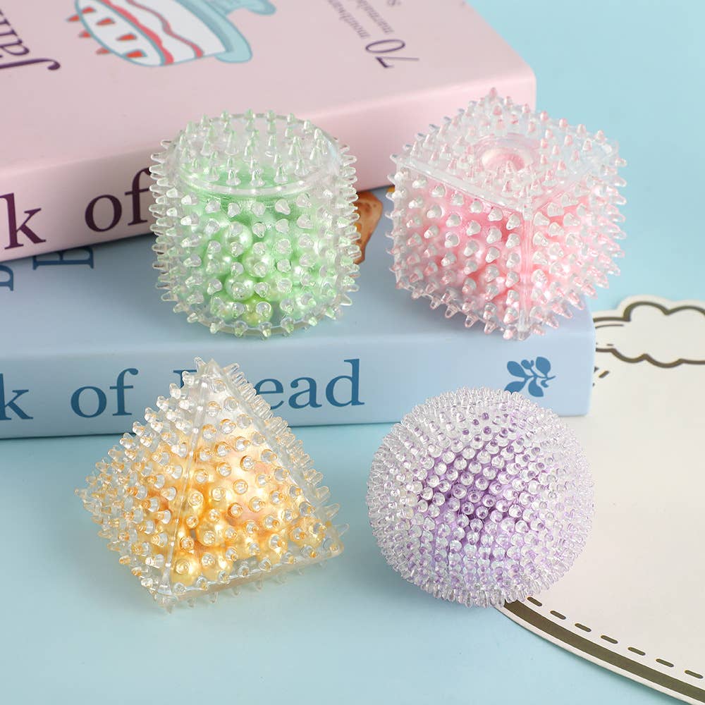 Pastel geometric squishy sensory toys filled with pearl beads in assorted shapes