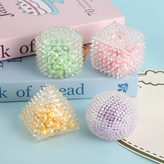 Pastel geometric squishy sensory toys filled with pearl beads in assorted shapes