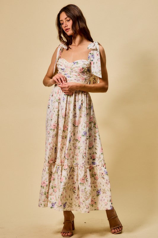 Woman wearing a floral dress against a beige background