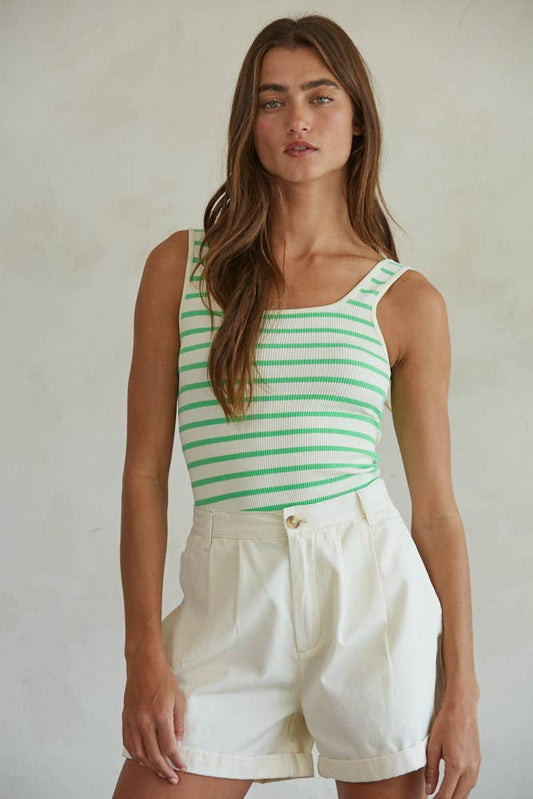 Woman wearing an ivory and key lime striped seamless ribbed square neck bodysuit paired with white cuffed shorts.