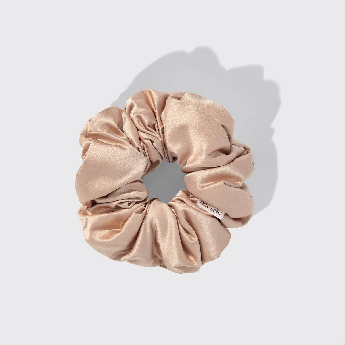 Beige scrunchie on a light gray background