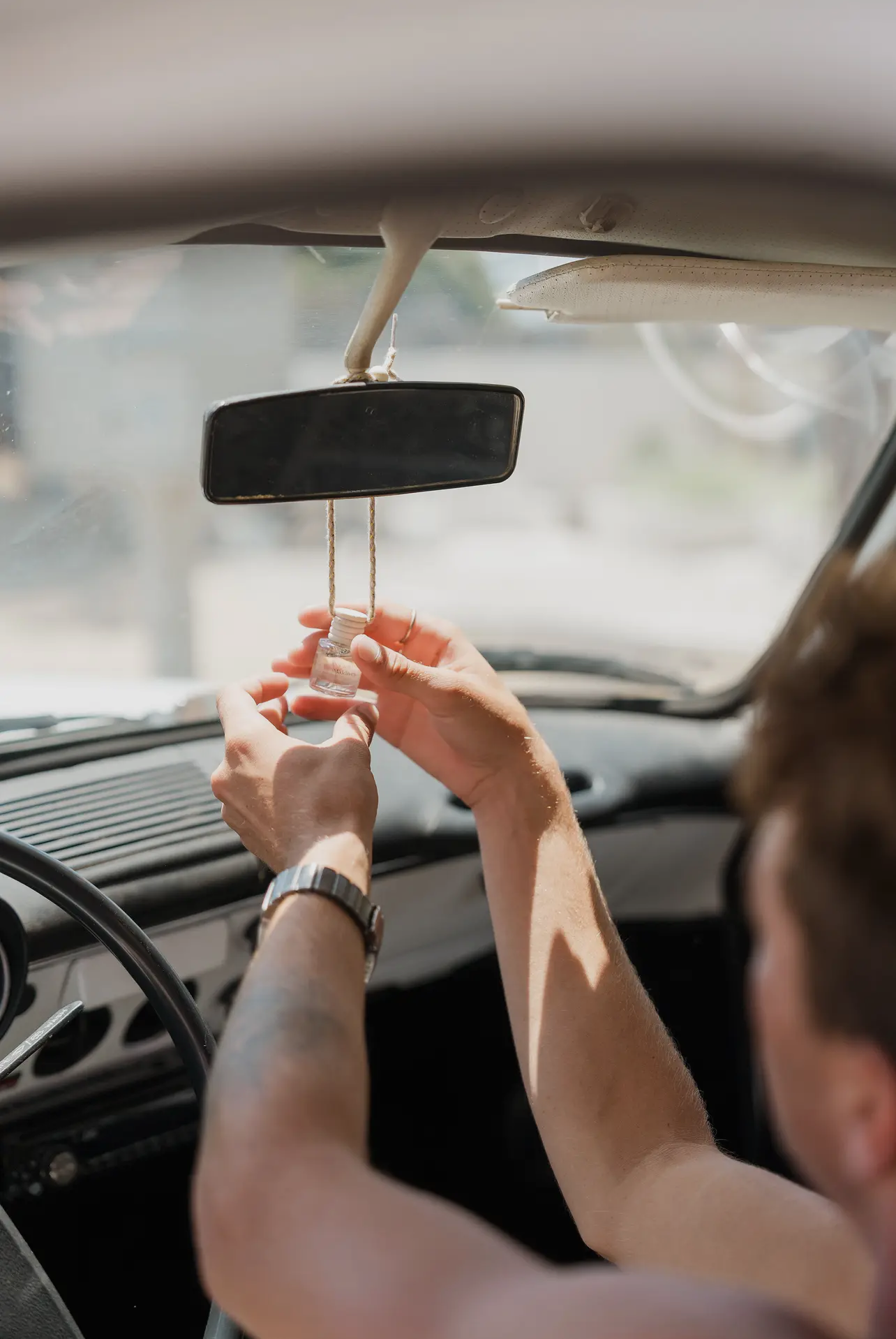 Santal 13 car diffuser hanging from rearview mirror
