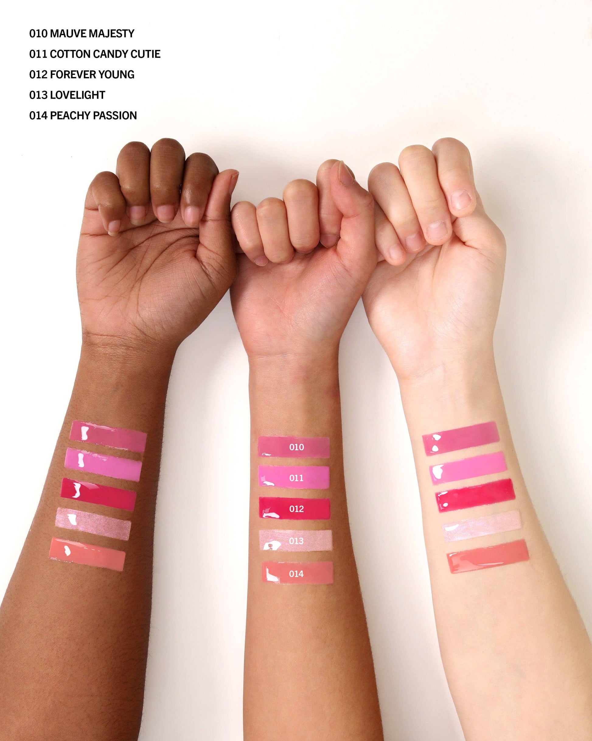 Three arms with pink lipstick swatches on a white background