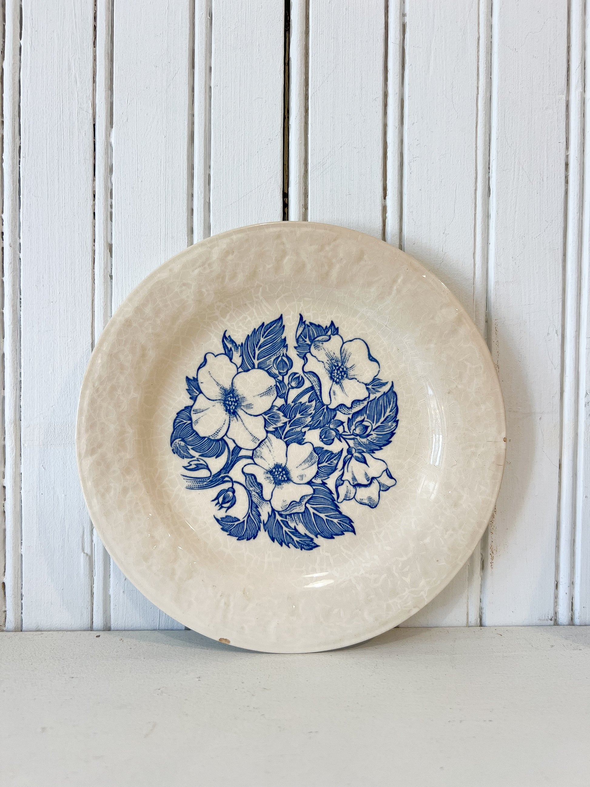 Vintage 7 inch blue and white floral ceramic plate with crackle glaze styled for FOUND & Co.