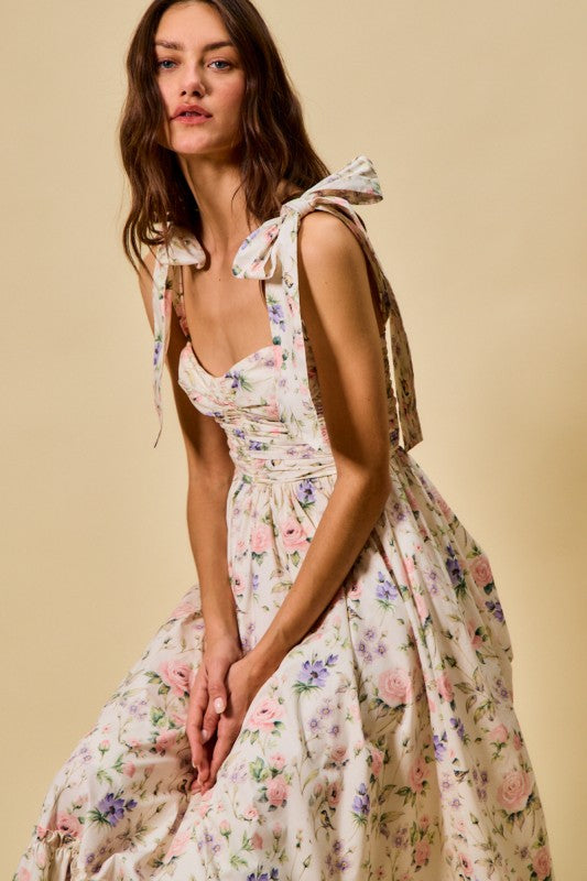 Woman wearing a floral dress with a beige background