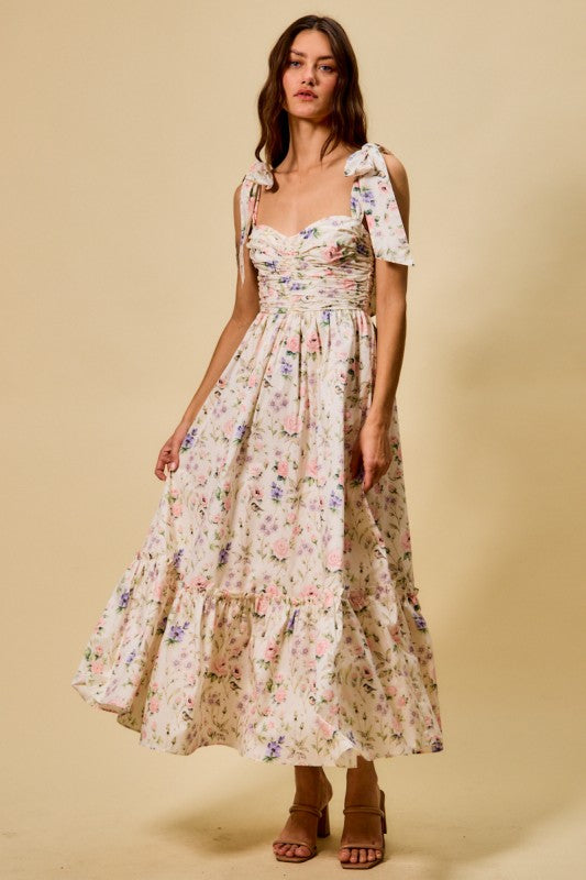 Woman wearing a floral dress against a beige background