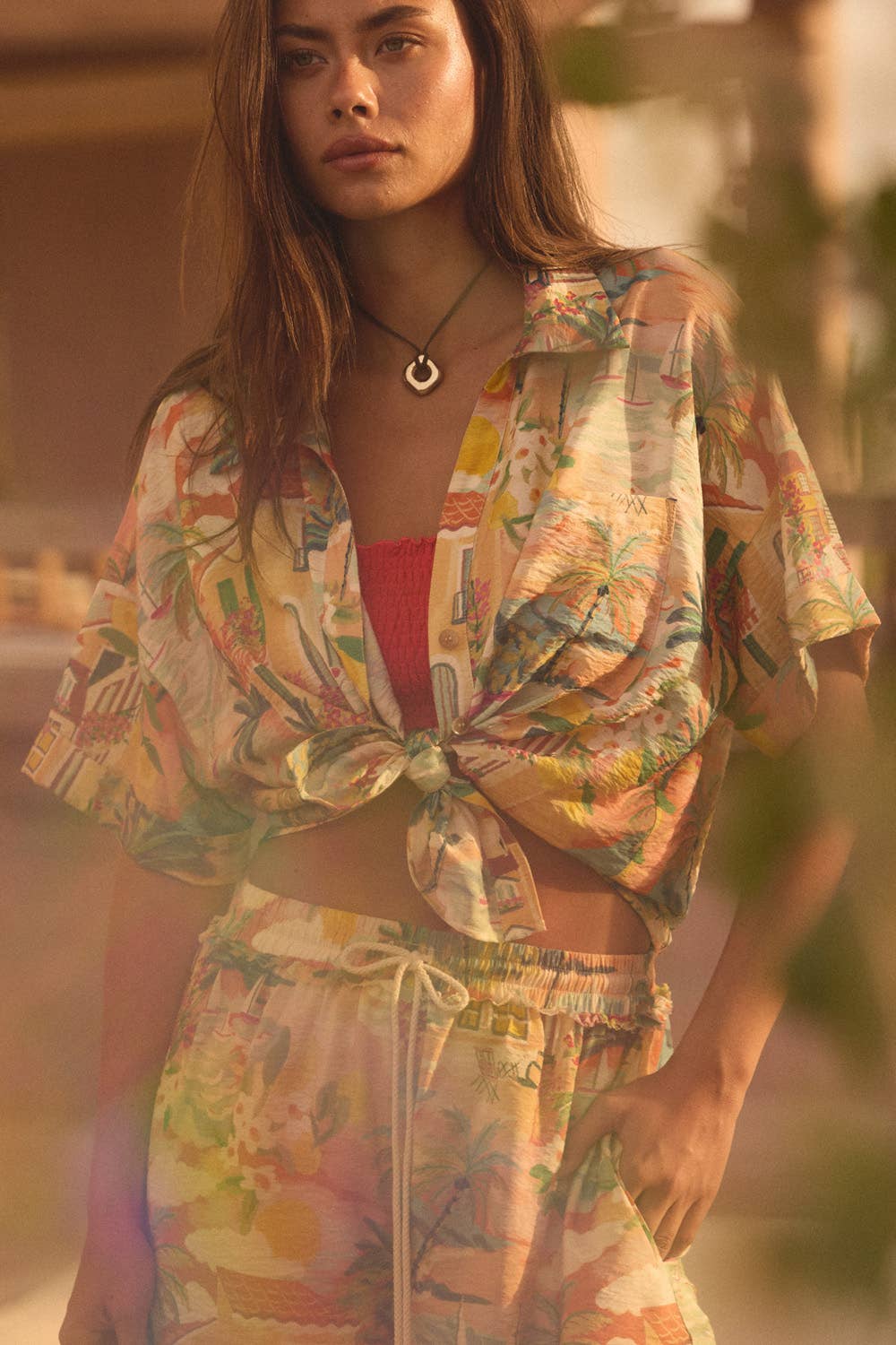 Woman wearing a tripical set-style outfit with a blurred background