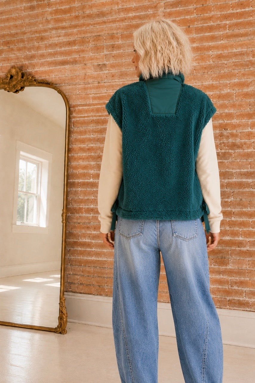     Back view of The Timberline Sherpa Vest showing its textured sherpa finish and contrast collar panel.