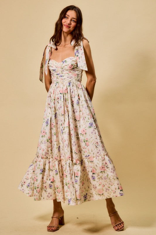 Woman wearing a floral dress against a beige background