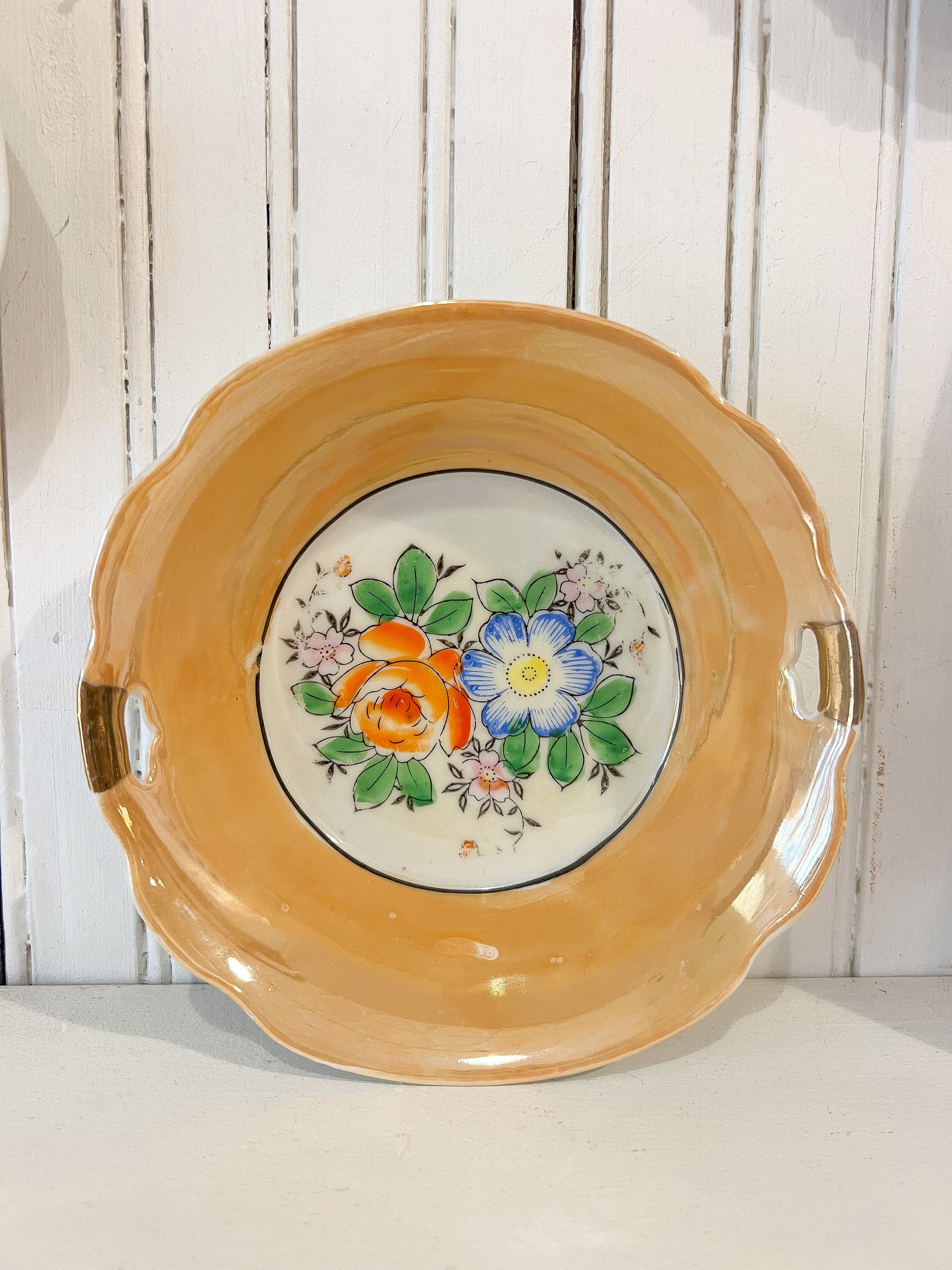Ceramic plate with floral design on a yellow background
