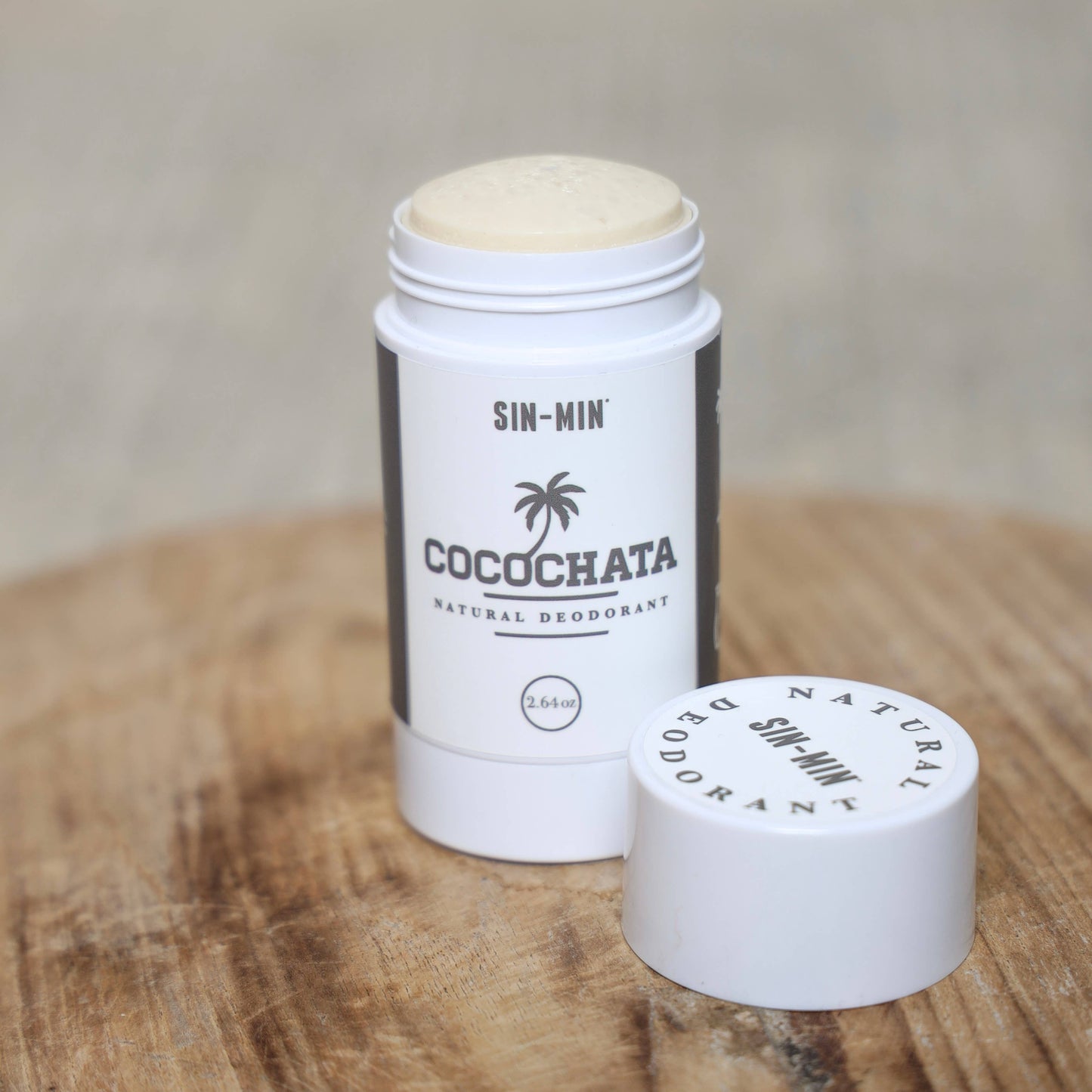 Cocochata natural deodorant stick on a wooden surface with a neutral background
