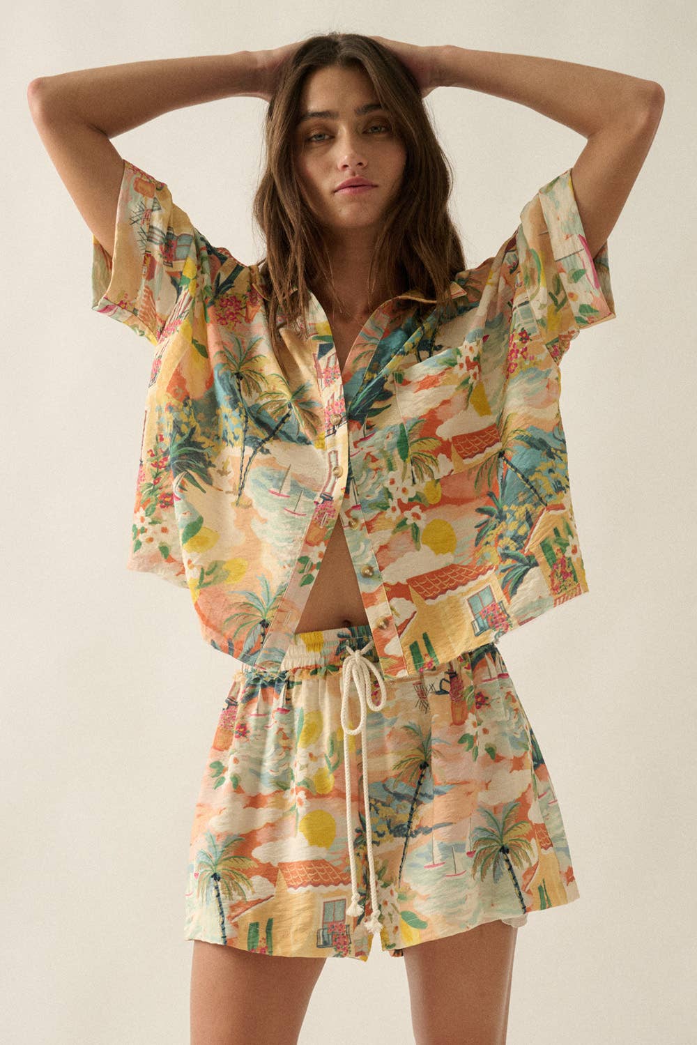 Woman wearing a colorful tropical outfit on a plain background