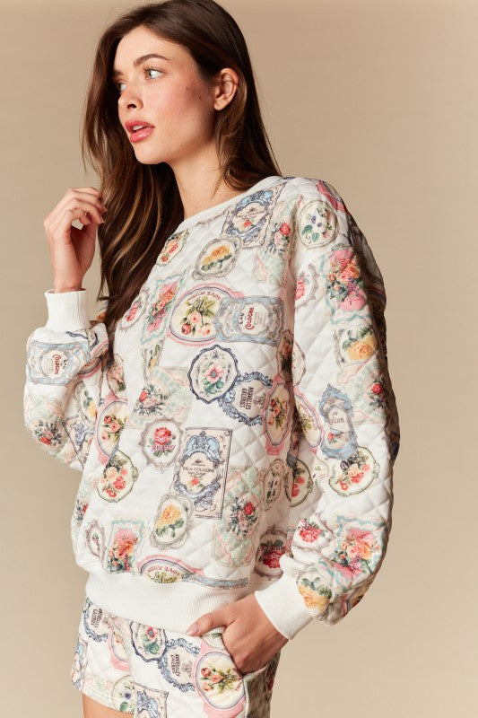 Woman wearing a patterned sweatshirt and shorts on a beige background