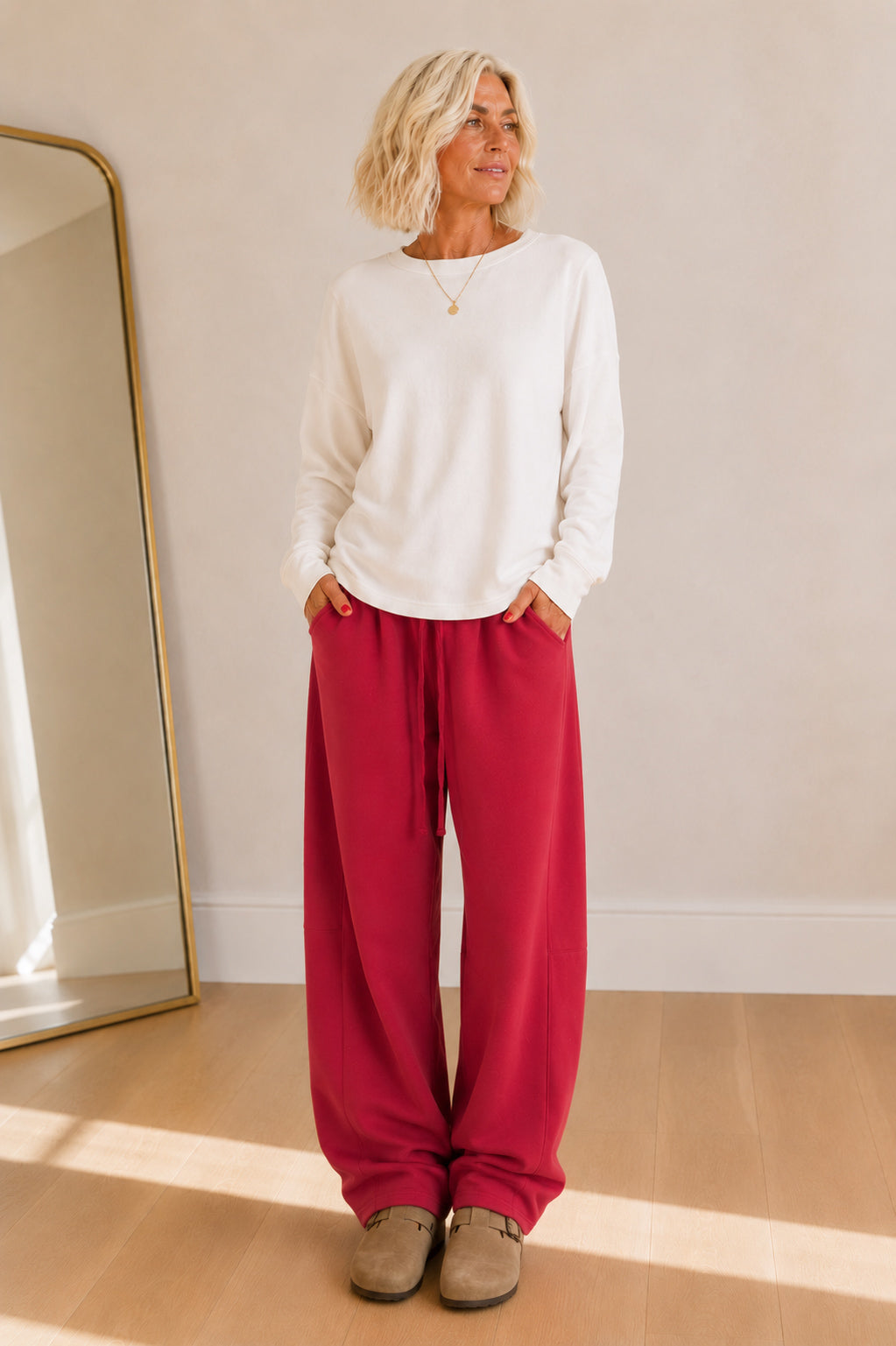 Rich cranberry barrel-leg sweatpants featuring an elastic waist and ultra-soft fabric.