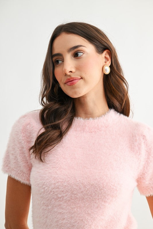 Close up of blush fuzzy knit fabric texture
