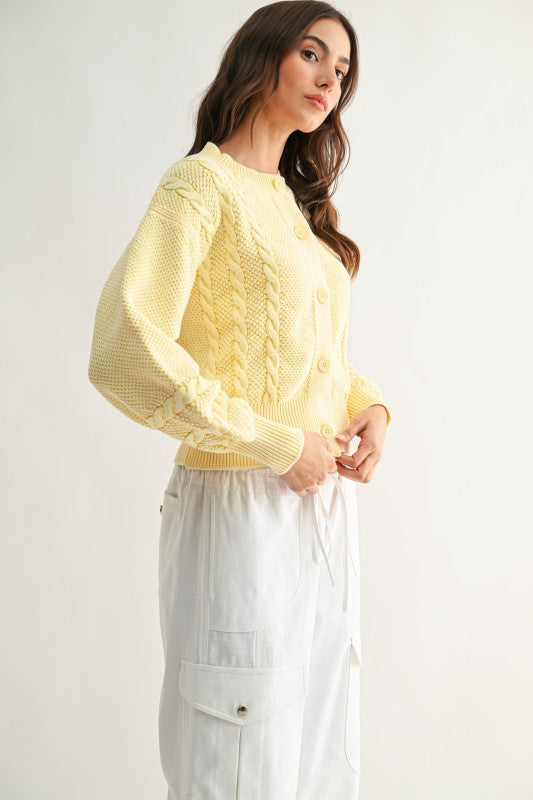 Side view of vintage inspired butter yellow cardigan with balloon sleeves