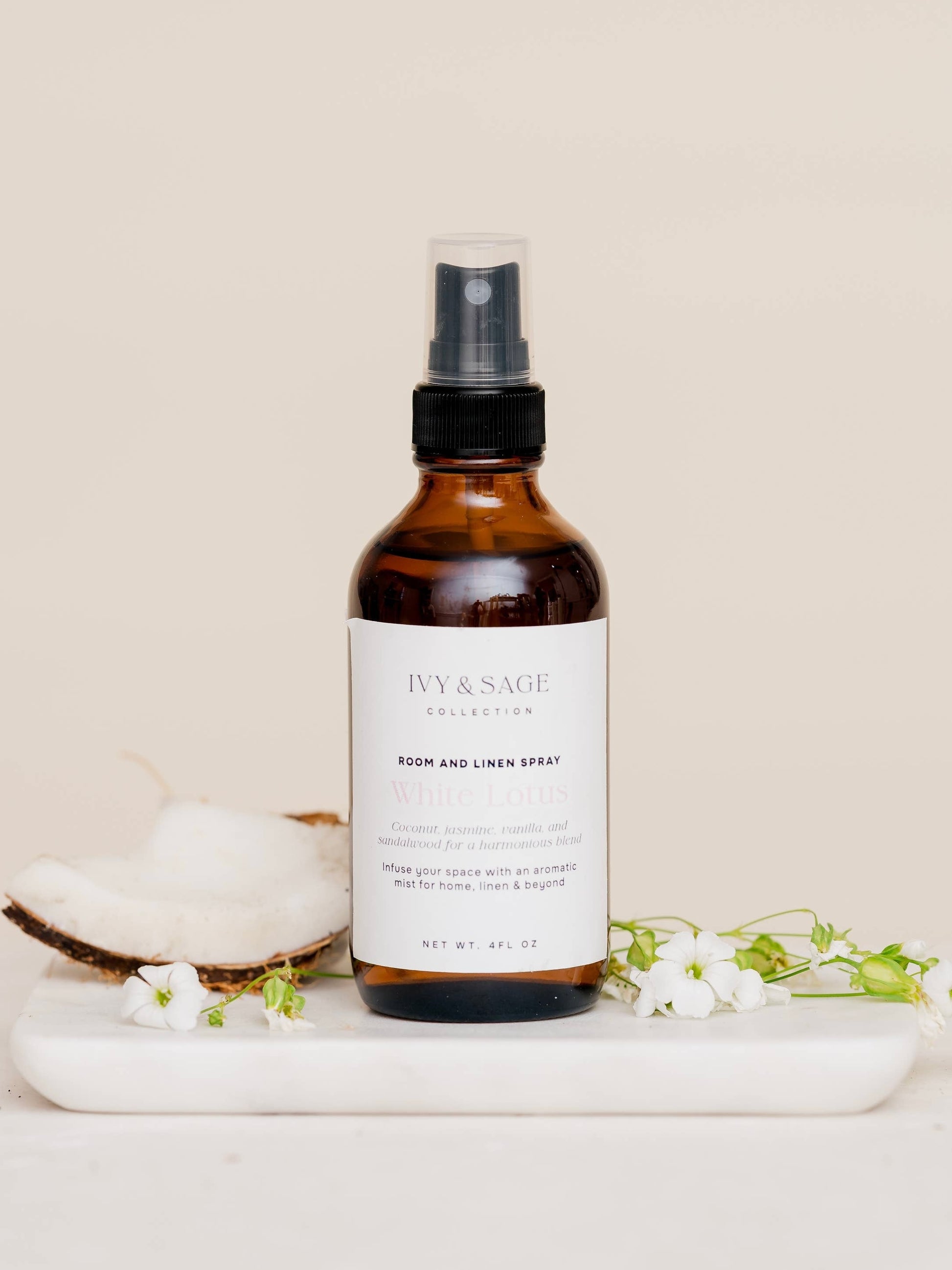 White lotus linen spray styled with soft neutral tones and cozy textures on a clean background
