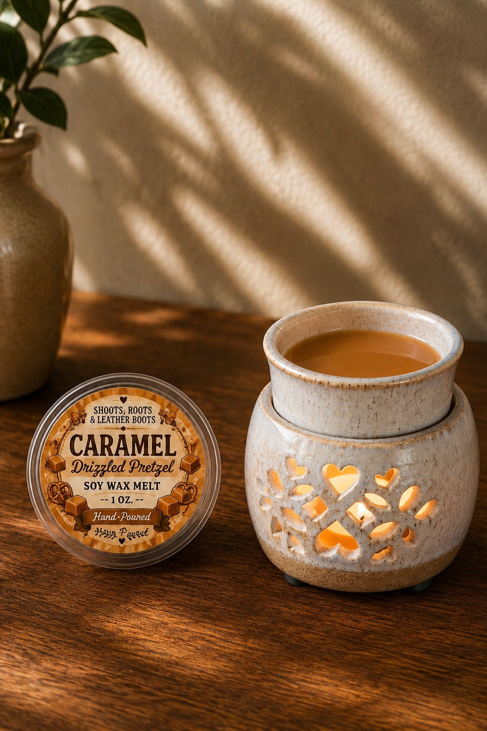 Caramel Drizzled Pretzel hand-poured soy wax melt beside a ceramic wax warmer.