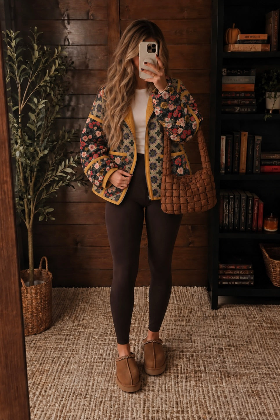 Woman wearing The Keepsake Quilted Jacket with mixed floral and geometric prints, golden trim and cream pants.