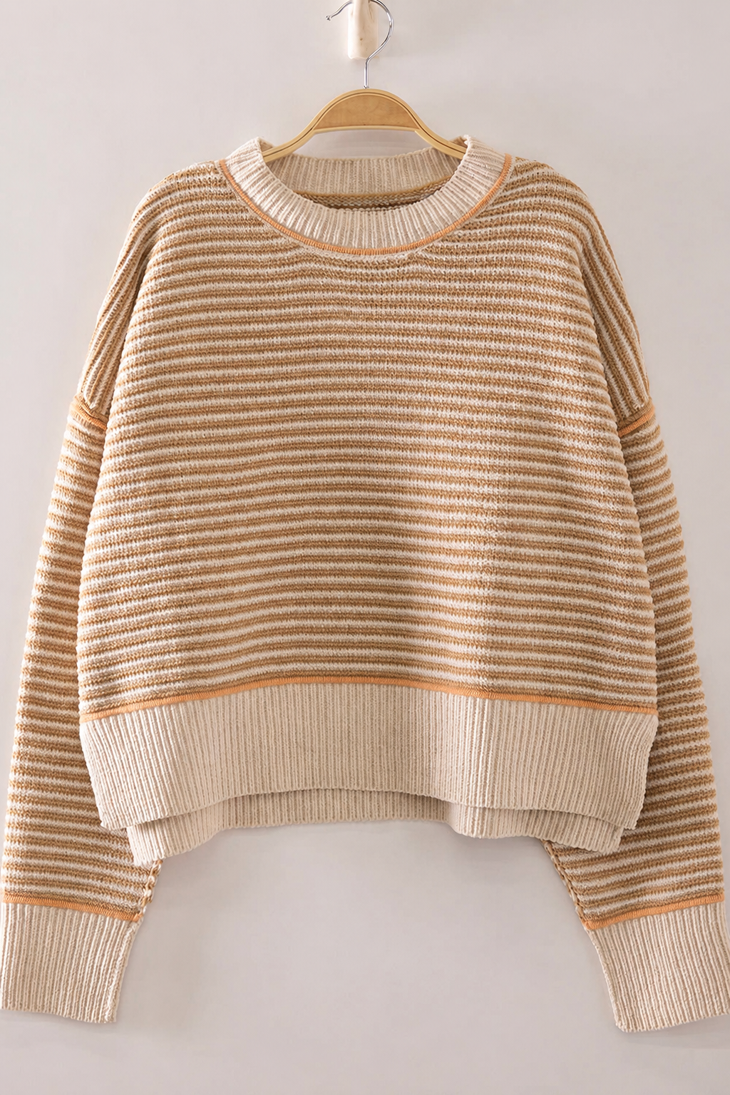 Front view of The Good Company Stripe Sweater in Toasted Oat with caramel micro stripes, apricot contrast stitching, and a wide ribbed hem.