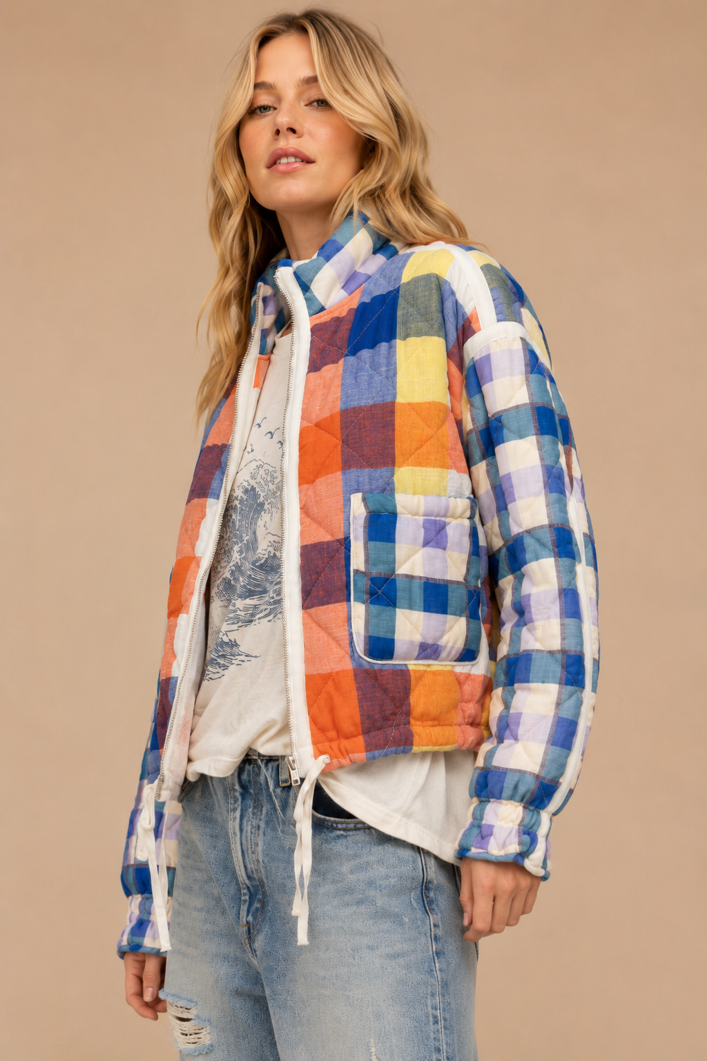 Colorful plaid quilted women’s jacket with a zip front, patch pockets and adjustable drawstring hem.
