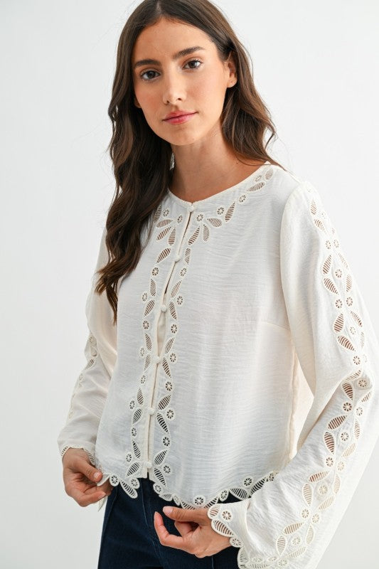 Ivory long sleeve lace blouse with scalloped embroidery and fabric-covered buttons, front close-up detail