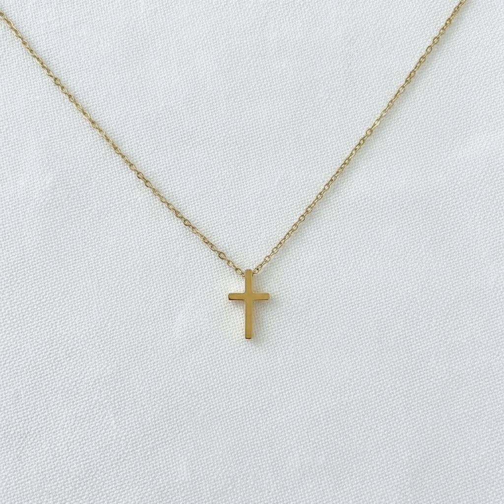Minimalist gold cross pendant necklace on delicate chain with adjustable extender
