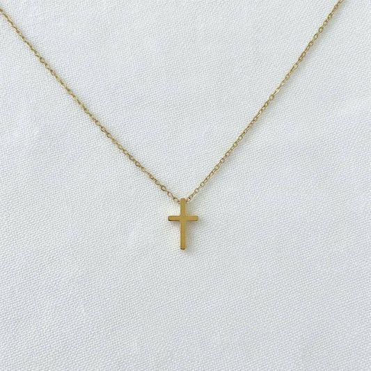 Minimalist gold cross pendant necklace on delicate chain with adjustable extender

