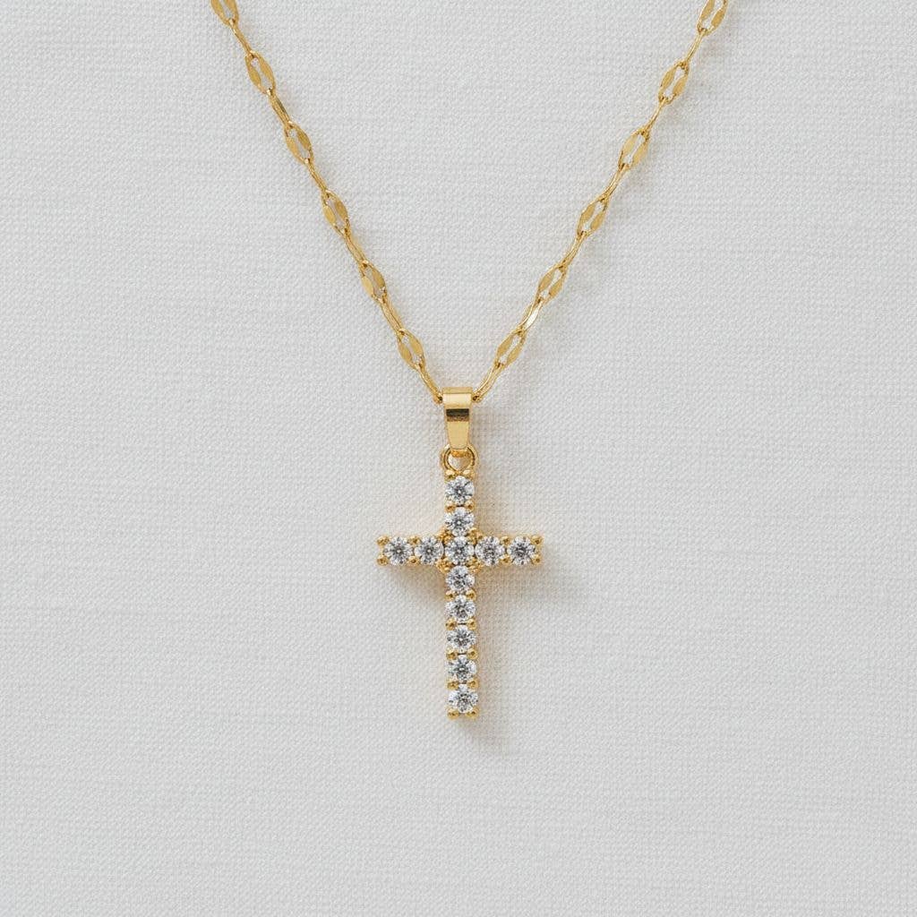 Gold zirconia cross pendant necklace with delicate chain and sparkling stones
