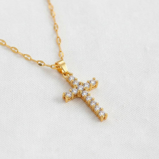 Gold zirconia cross pendant necklace with delicate chain and sparkling stones
