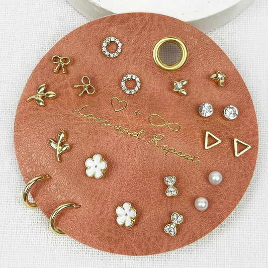 Gold stud earring set with 9 pairs including bows, pearls, florals, and crystal studs